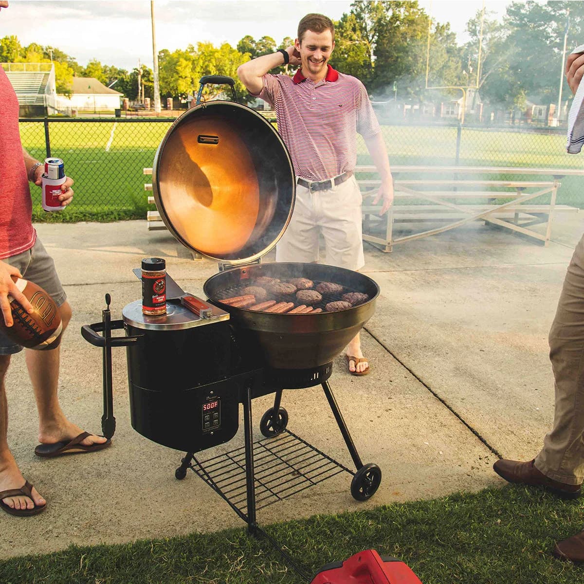 Friends gathered around a Bullseye in a backyard