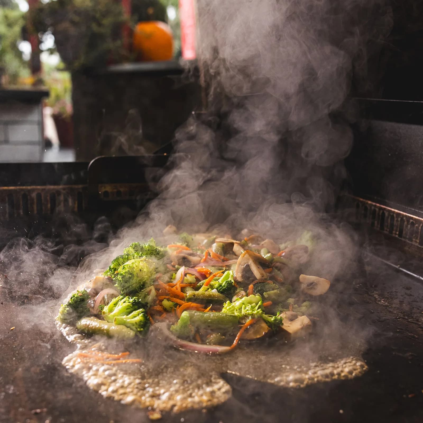 Vegetables and steam on a SmokeStone griddle